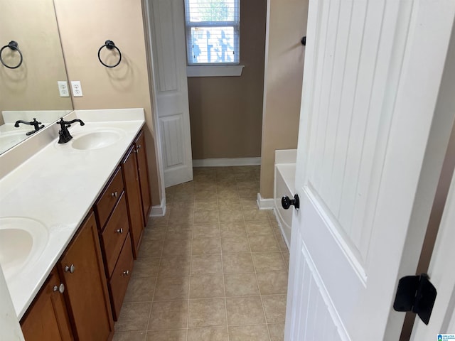 bathroom featuring a bath, tile patterned flooring, and vanity