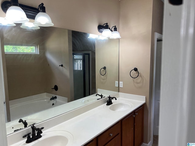 bathroom with a tub and vanity