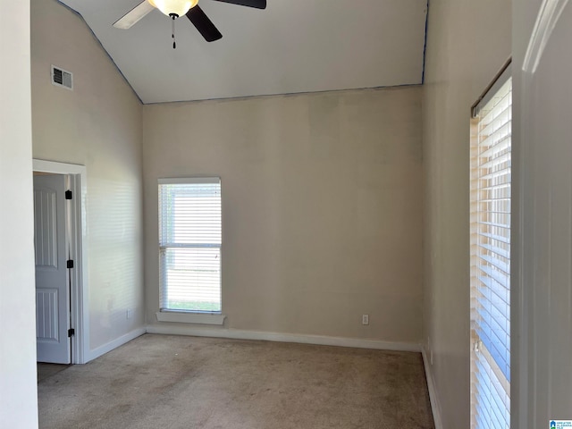 empty room featuring light carpet, high vaulted ceiling, and ceiling fan