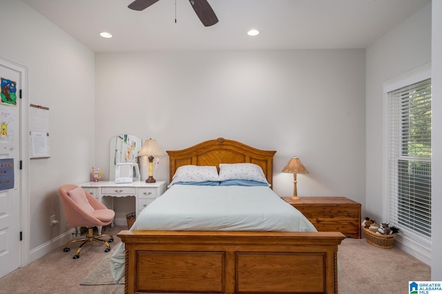 bedroom with ceiling fan and light carpet