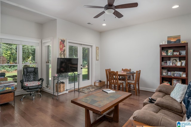 living room with ceiling fan and dark hardwood / wood-style flooring