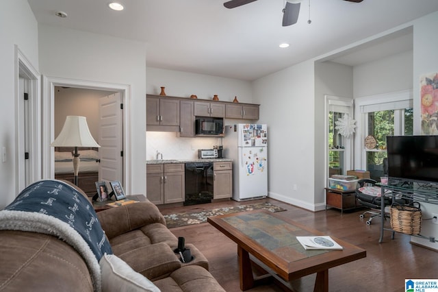 living room featuring ceiling fan, sink, and dark hardwood / wood-style floors