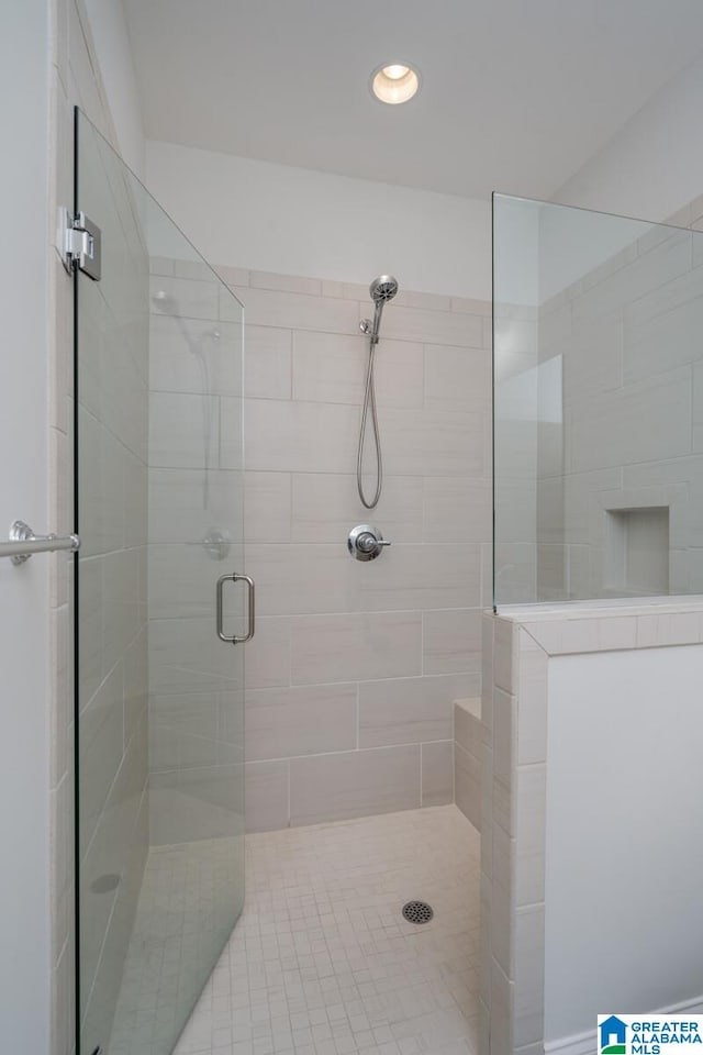 bathroom featuring a shower with shower door