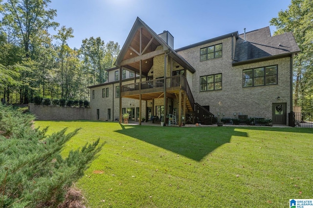 rear view of house with a lawn and a deck