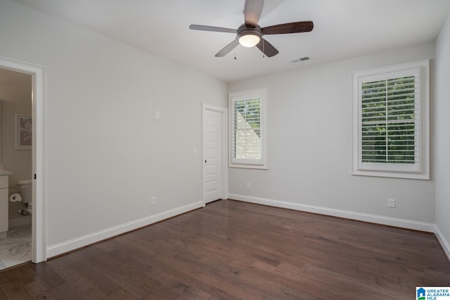 spare room with ceiling fan and dark hardwood / wood-style flooring