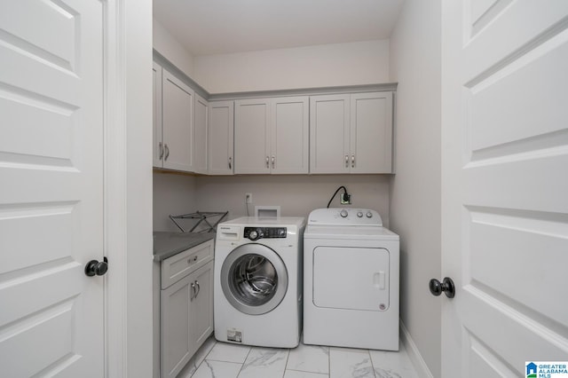 laundry area featuring cabinets and washing machine and dryer