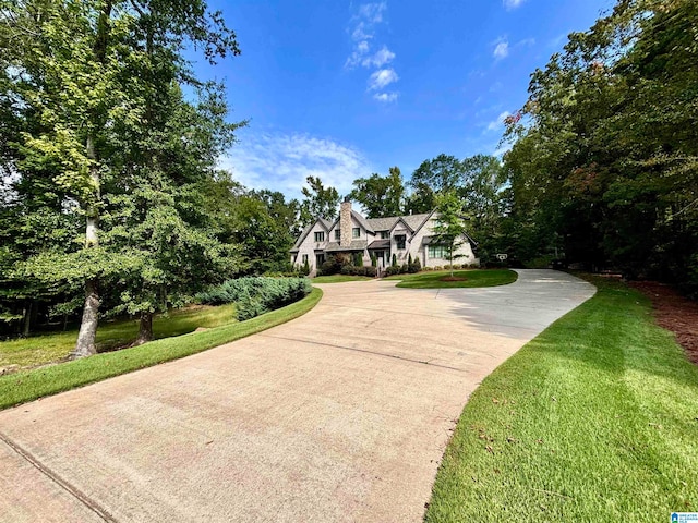 english style home featuring a front yard