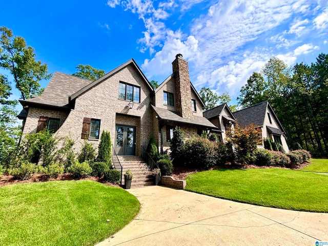 view of front of property featuring a front yard and french doors