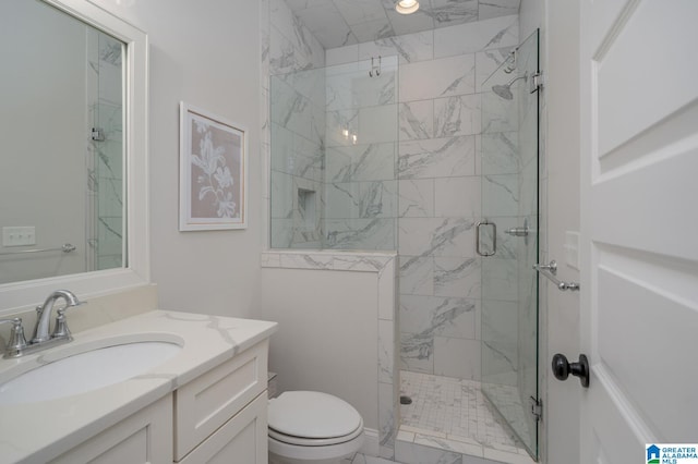 bathroom featuring vanity, an enclosed shower, and toilet