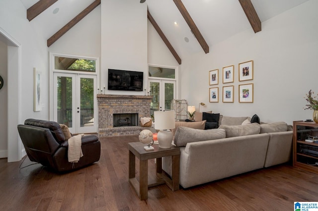 living room featuring hardwood / wood-style floors, high vaulted ceiling, french doors, a brick fireplace, and beamed ceiling