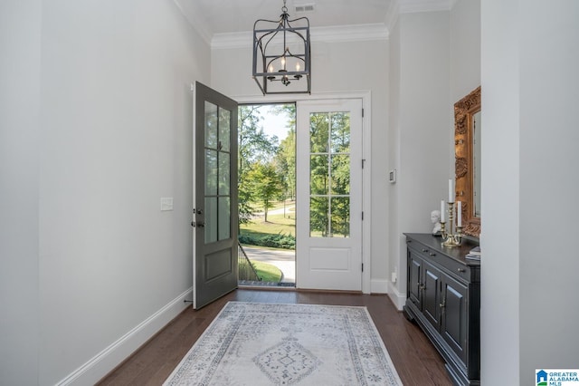 doorway with a notable chandelier, dark hardwood / wood-style flooring, and crown molding