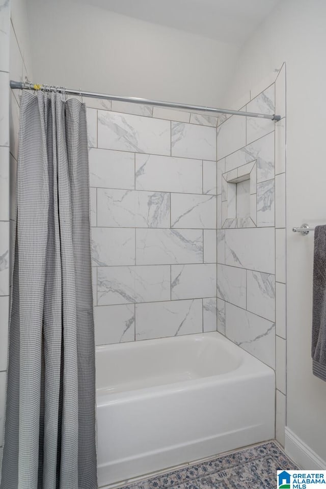 bathroom with shower / tub combo with curtain