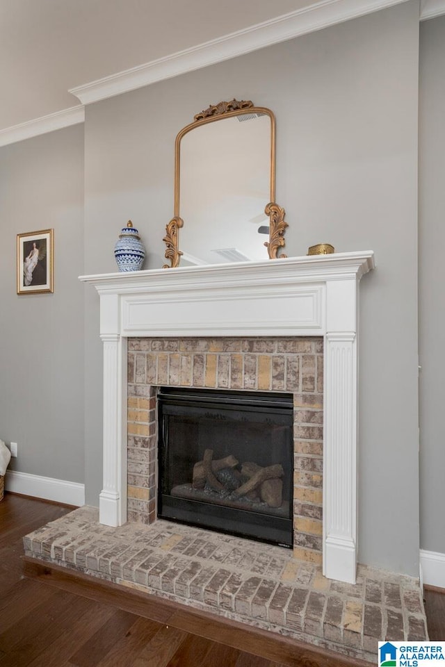 room details featuring a fireplace, hardwood / wood-style floors, and ornamental molding