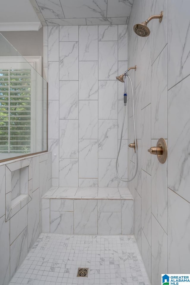 bathroom with a tile shower