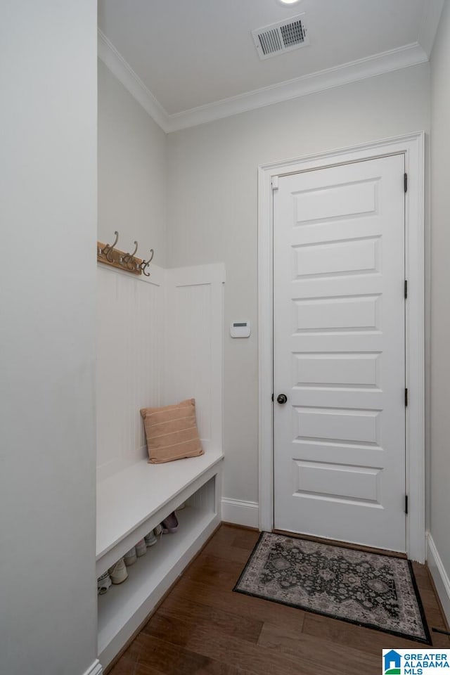 mudroom with dark hardwood / wood-style flooring and crown molding