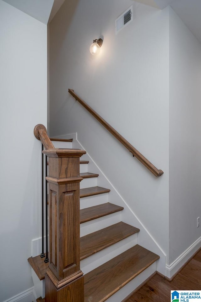 stairs featuring hardwood / wood-style floors