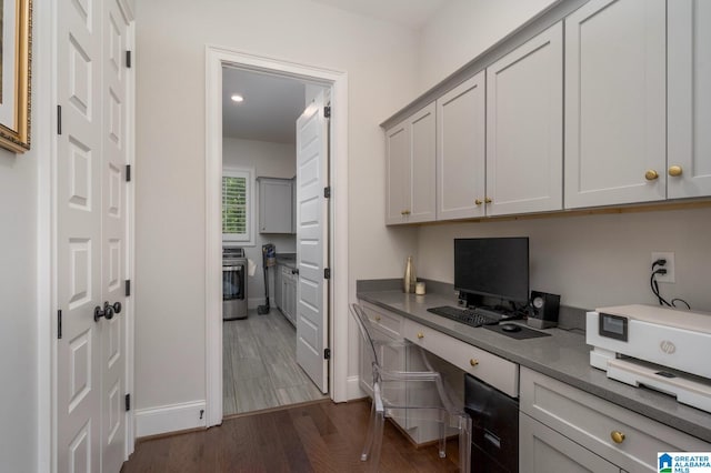 office featuring built in desk and dark wood-type flooring