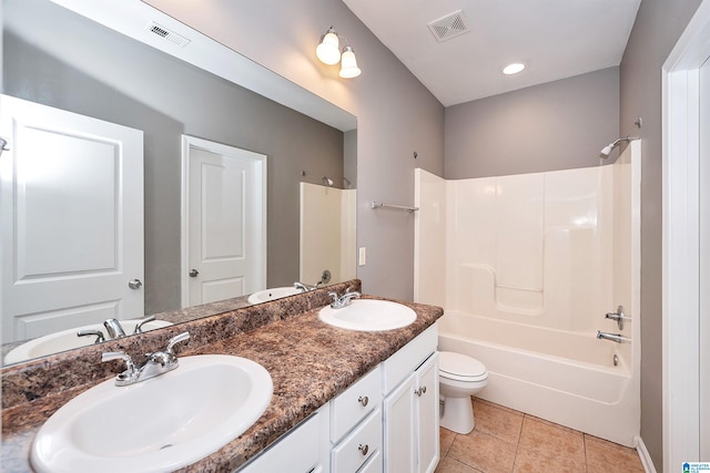 full bathroom with tile patterned floors, shower / bathtub combination, toilet, and vanity