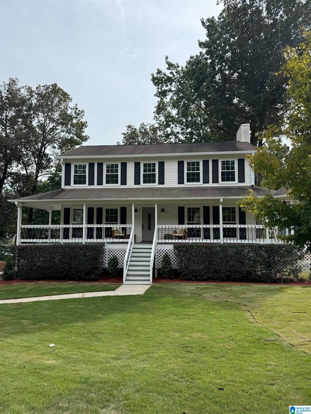 view of front of house featuring a front lawn and covered porch