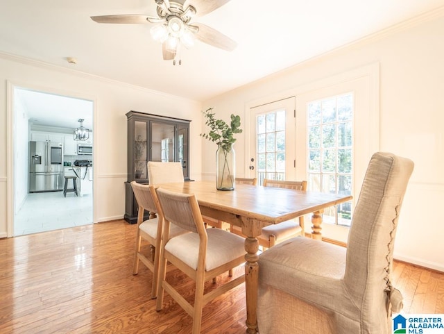 dining space with crown molding, light hardwood / wood-style floors, and ceiling fan