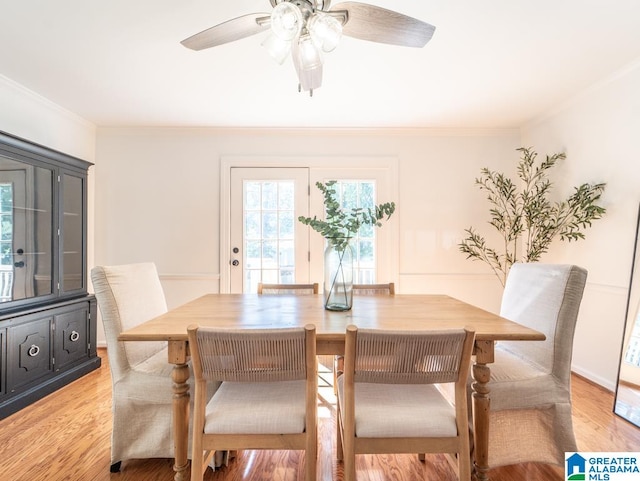 dining space featuring ceiling fan, crown molding, and light hardwood / wood-style floors