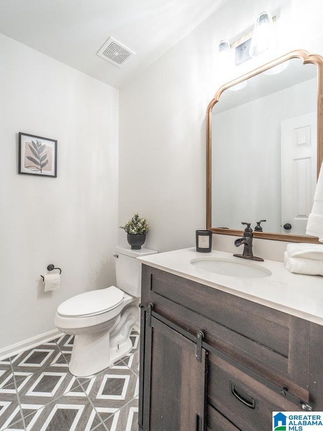 bathroom featuring vanity and toilet