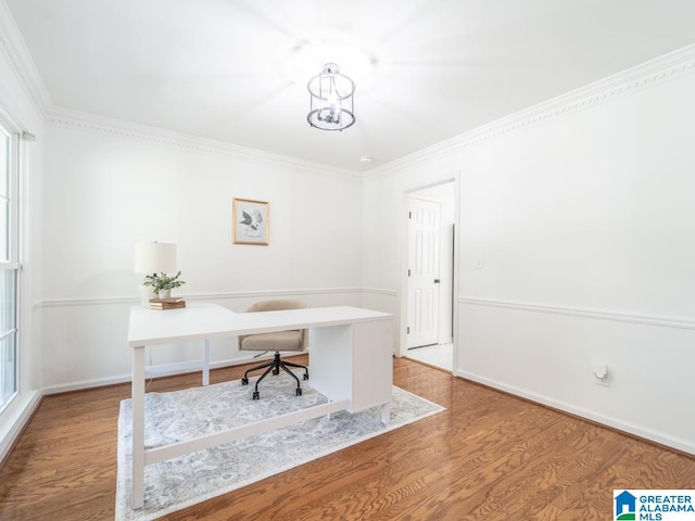 home office with crown molding, a chandelier, and hardwood / wood-style flooring