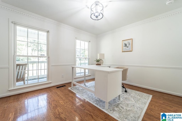 office space featuring ornamental molding, an inviting chandelier, and hardwood / wood-style flooring