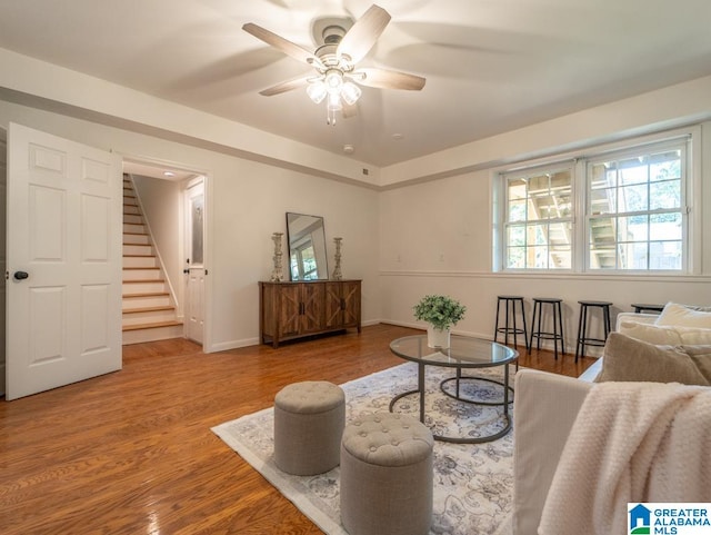 living room featuring ceiling fan and hardwood / wood-style floors