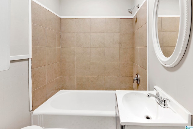 full bathroom featuring vanity, toilet, and tiled shower / bath