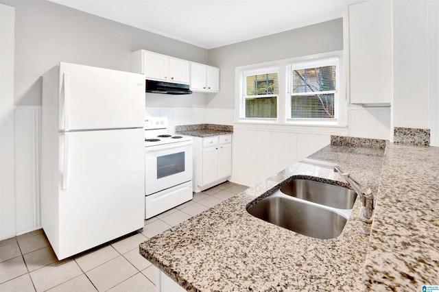 kitchen featuring white appliances, light stone counters, sink, and white cabinets