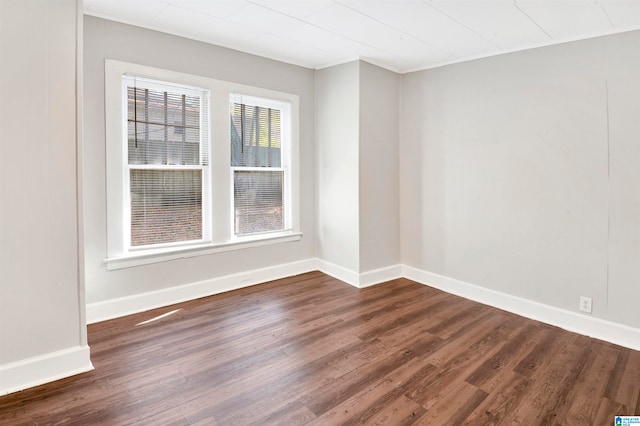 unfurnished room with dark hardwood / wood-style floors