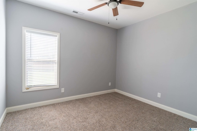 carpeted empty room featuring ceiling fan