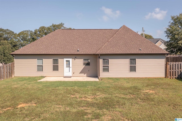 rear view of house with a patio area and a lawn