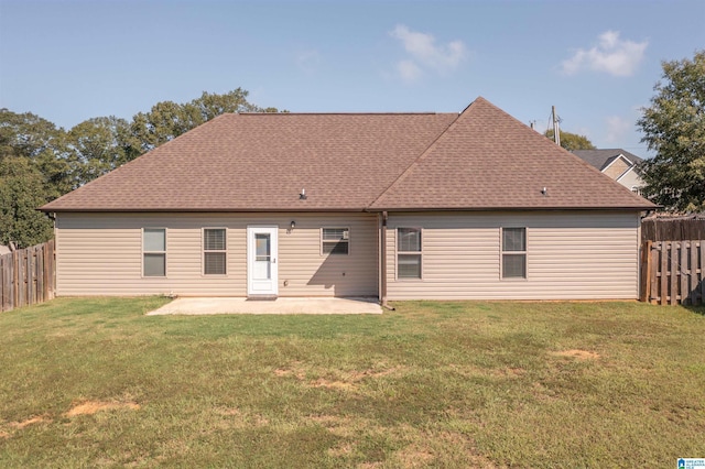 back of property with a yard and a patio