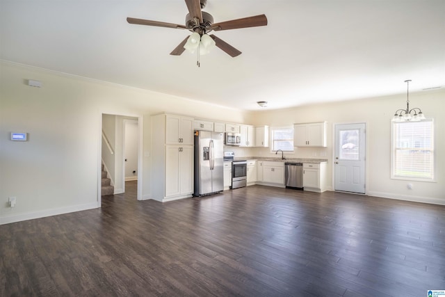 unfurnished living room featuring sink, ceiling fan with notable chandelier, and dark hardwood / wood-style floors