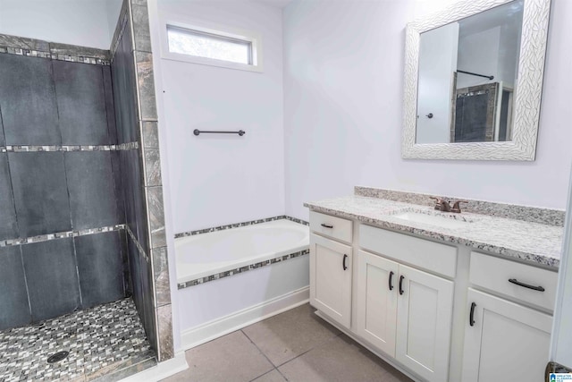 bathroom featuring shower with separate bathtub, vanity, and tile patterned floors