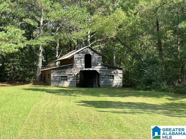 view of outbuilding with a yard