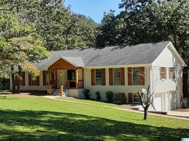 view of front of home featuring a garage, a front yard, and covered porch