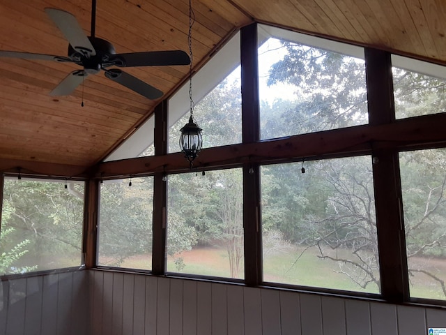 room details featuring ceiling fan, wood walls, and wooden ceiling