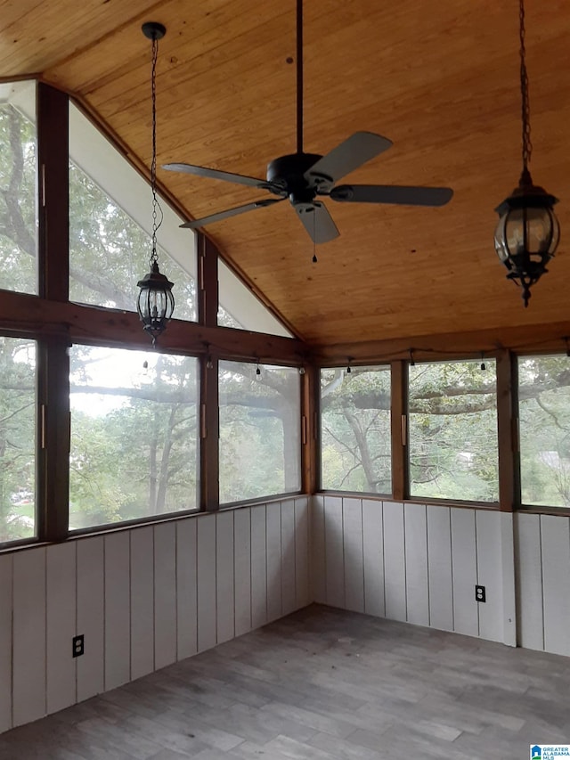 unfurnished sunroom featuring ceiling fan, wood ceiling, and lofted ceiling