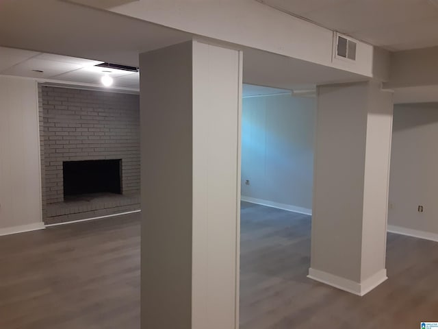 basement with a fireplace and dark hardwood / wood-style floors