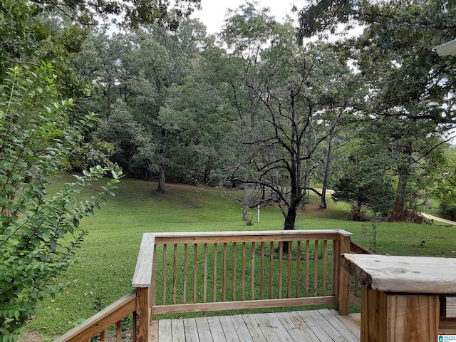 wooden deck with a lawn