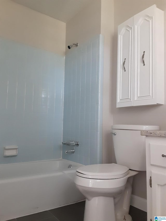 full bathroom featuring tiled shower / bath, vanity, toilet, and tile patterned floors