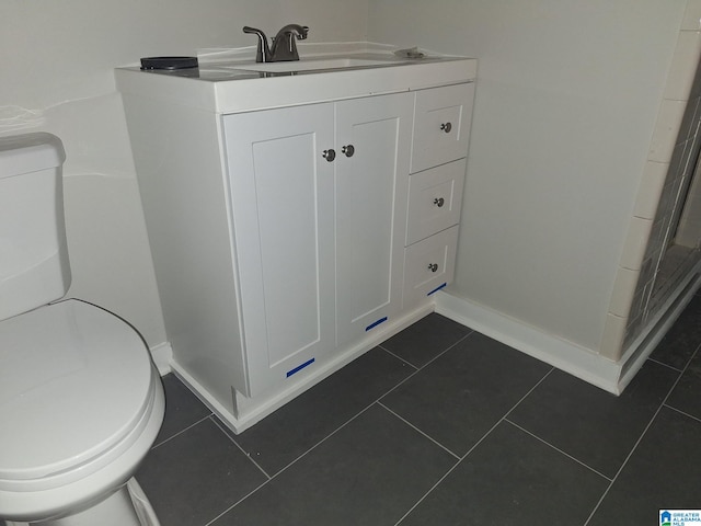 bathroom featuring vanity, toilet, and tile patterned floors