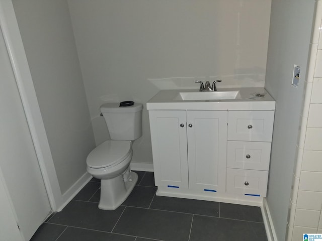 bathroom with tile patterned flooring, vanity, and toilet