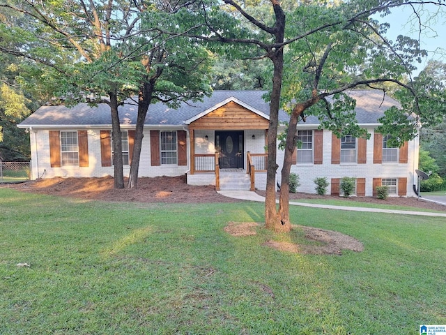 ranch-style house featuring a porch and a front lawn