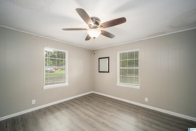 unfurnished room featuring wood-type flooring, ceiling fan, a textured ceiling, and crown molding