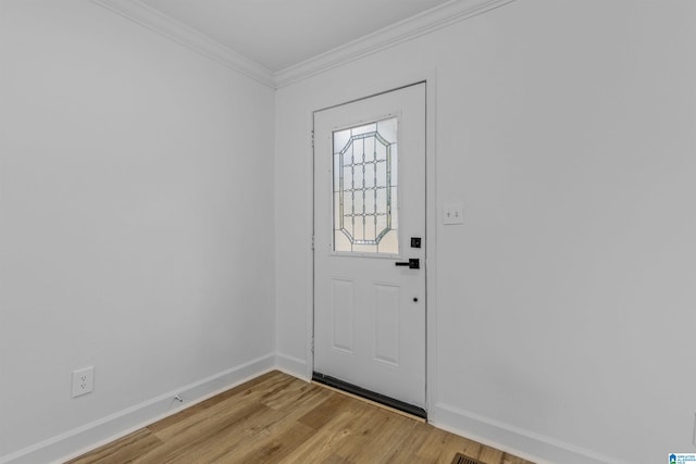 foyer entrance featuring ornamental molding and light hardwood / wood-style flooring