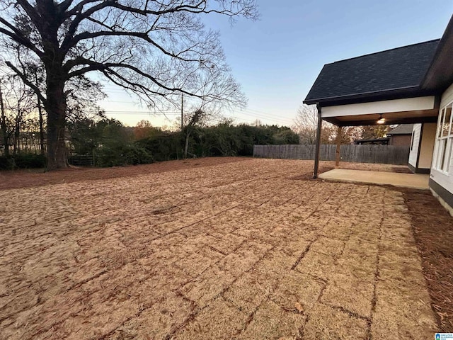 yard at dusk with a patio